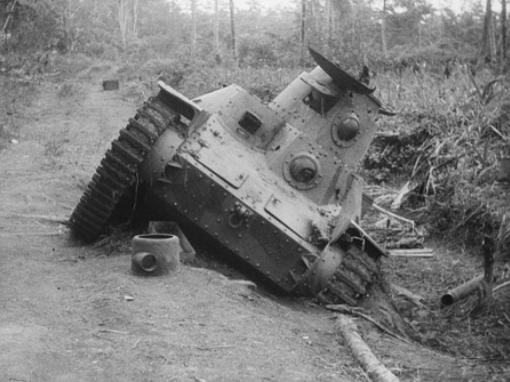 A Japanese Type 95 Ha-Go tank near Rabi, bogged in the mud and abandoned.
